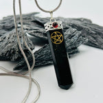Black Tourmaline Pentacle Pendant Encased In White Metal With A Garnet Cabochon